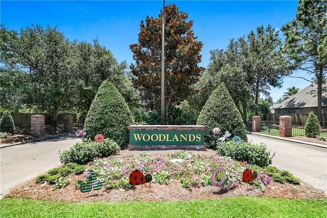 community sign featuring fence