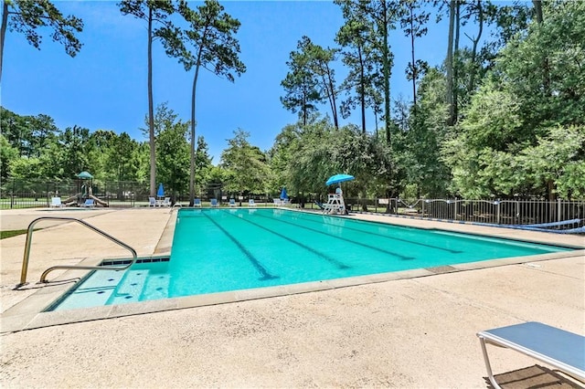 community pool featuring fence and a patio