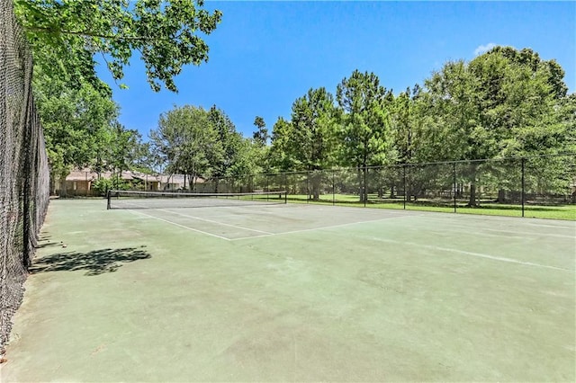 view of tennis court with fence