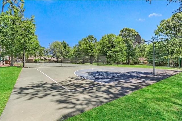 view of sport court featuring community basketball court, fence, a tennis court, and a yard