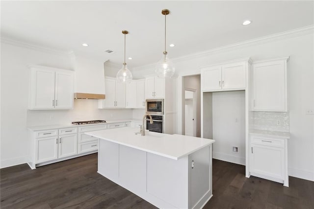 kitchen with dark wood finished floors, appliances with stainless steel finishes, backsplash, and white cabinets