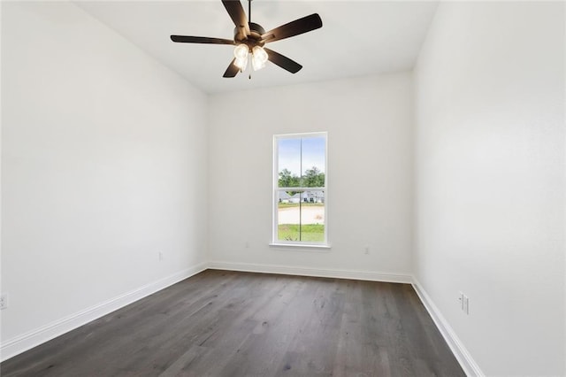 unfurnished room featuring baseboards, ceiling fan, and dark wood finished floors
