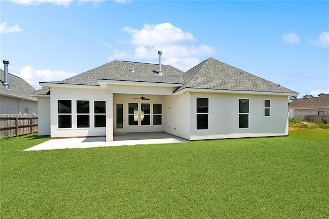 rear view of house with stucco siding, ceiling fan, roof with shingles, and fence