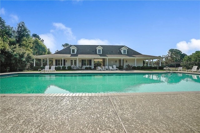 pool with fence and a patio