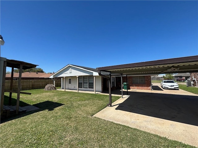 1871 George St, Lutcher, LA 70071 - back of house featuring a carport, a lawn, and fence