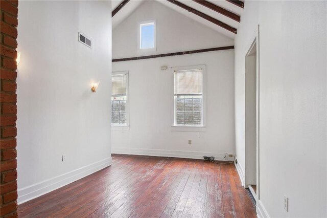 933 Orleans St Unit 4, New Orleans, LA 70116 - spare room featuring wood-type flooring, beam ceiling, and high vaulted ceiling