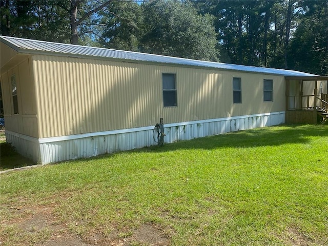 view of side of home featuring a lawn