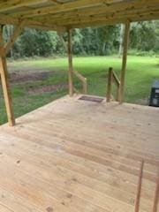 wooden deck featuring a yard