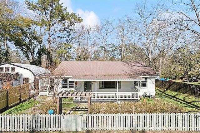1612 Mossy St, Covington, LA 70433 - single story home with a fenced front yard, a porch, and metal roof
