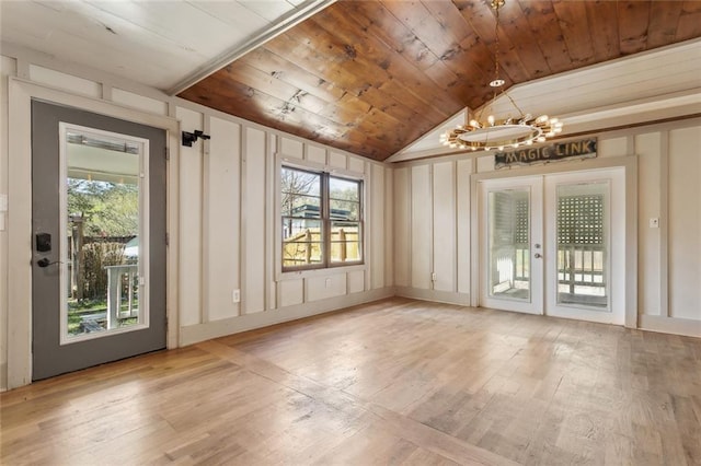1612 Mossy St, Covington, LA 70433 - unfurnished room featuring an inviting chandelier, a wealth of natural light, wood finished floors, and wooden ceiling