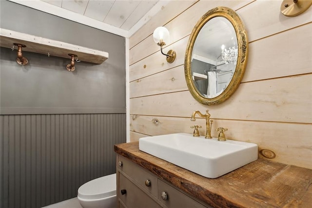 1612 Mossy St, Covington, LA 70433 - bathroom featuring wooden walls, vanity, and toilet
