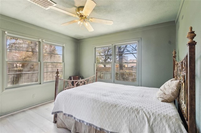 1612 Mossy St, Covington, LA 70433 - bedroom with ceiling fan and a textured ceiling