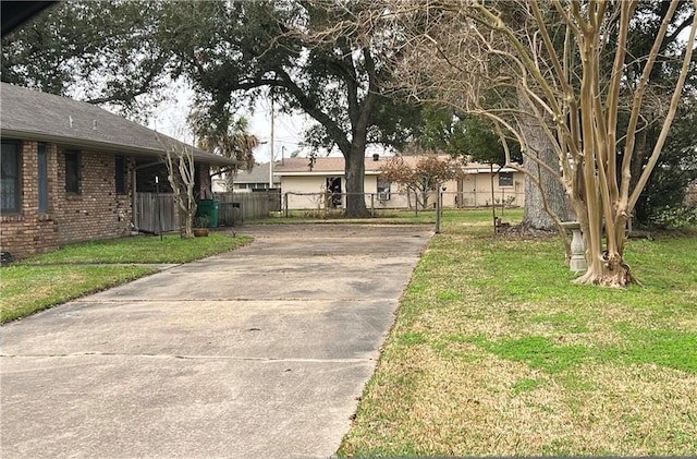 137 Nolan Dr, La Place, LA 70068 - view of front of home with brick siding, a front yard, fence, and driveway