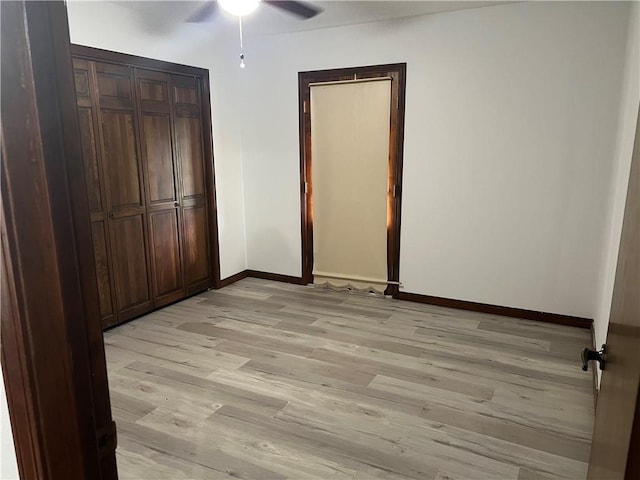 137 Nolan Dr, La Place, LA 70068 - unfurnished bedroom featuring a closet, light wood-type flooring, baseboards, and a ceiling fan