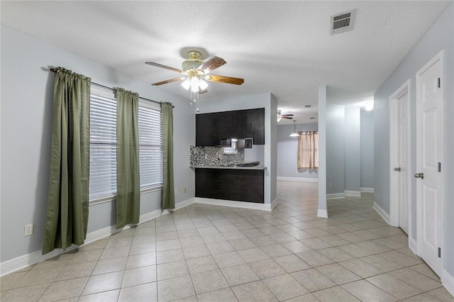 302 Bogie Dr Unit 25D, Slidell, LA 70460 - unfurnished living room with ceiling fan, light tile patterned flooring, and a textured ceiling