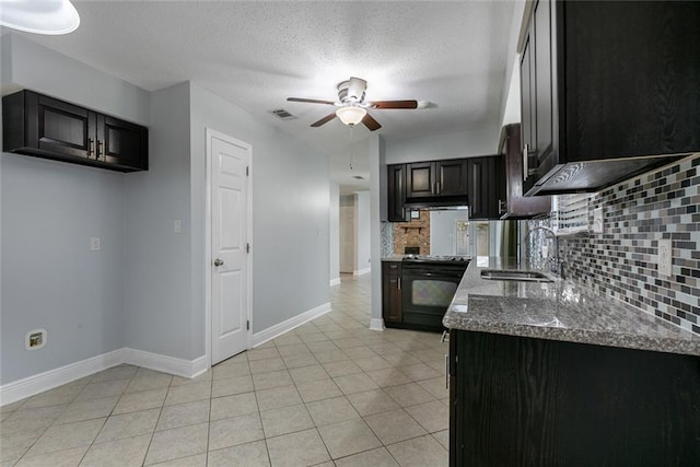 302 Bogie Dr Unit 25D, Slidell, LA 70460 - kitchen with black range with electric stovetop, tasteful backsplash, a ceiling fan, under cabinet range hood, and light tile patterned floors