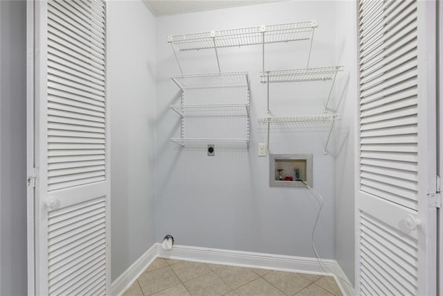 302 Bogie Dr Unit 25D, Slidell, LA 70460 - laundry area featuring hookup for a washing machine, hookup for an electric dryer, and light tile patterned flooring
