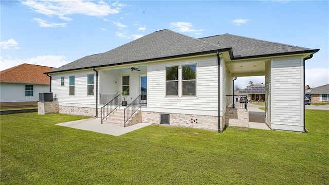 8520 Creole Dr, Chalmette, LA 70043 - rear view of house with a yard, central air condition unit, ceiling fan, and a shingled roof