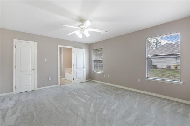 unfurnished bedroom featuring baseboards, visible vents, and light carpet