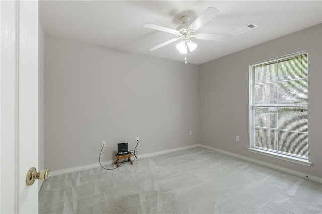 spare room with baseboards, visible vents, and carpet floors