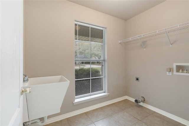 laundry room featuring hookup for a washing machine, baseboards, a sink, electric dryer hookup, and laundry area