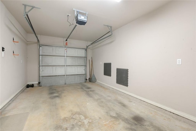 garage with baseboards and a garage door opener