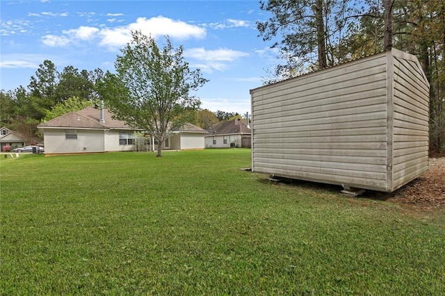 view of yard with an outbuilding and a shed