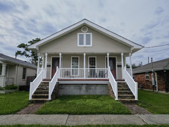 5930 Louisville St, New Orleans, LA 70124 - bungalow-style home featuring a front yard, a porch, and stairs