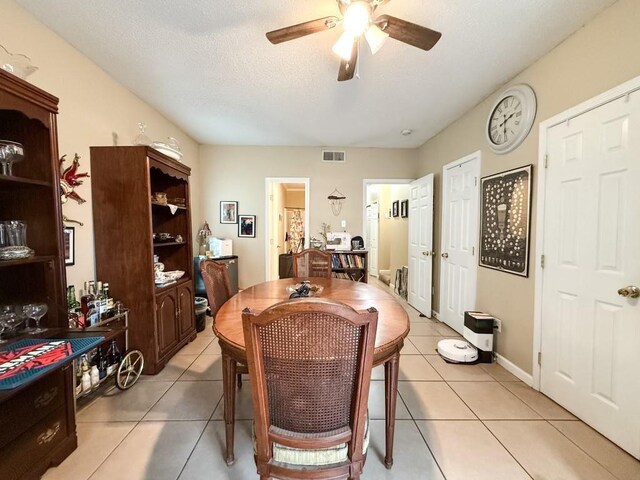 5930 Louisville St, New Orleans, LA 70124 - dining space featuring light tile patterned floors, visible vents, a textured ceiling, and a ceiling fan