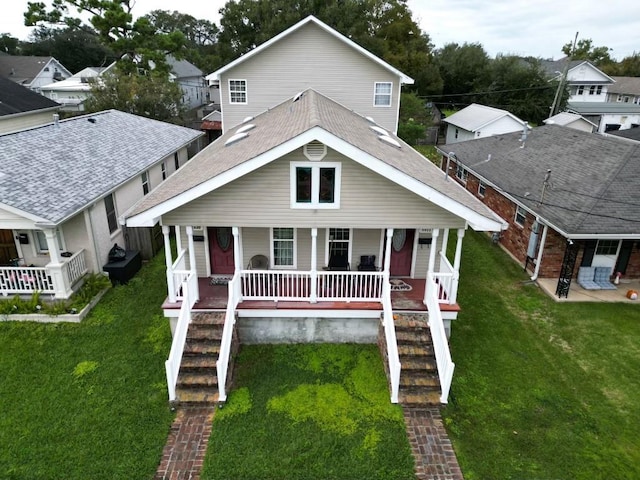 5930 Louisville St, New Orleans, LA 70124 - view of front of house with a front lawn, covered porch, stairs, and roof with shingles
