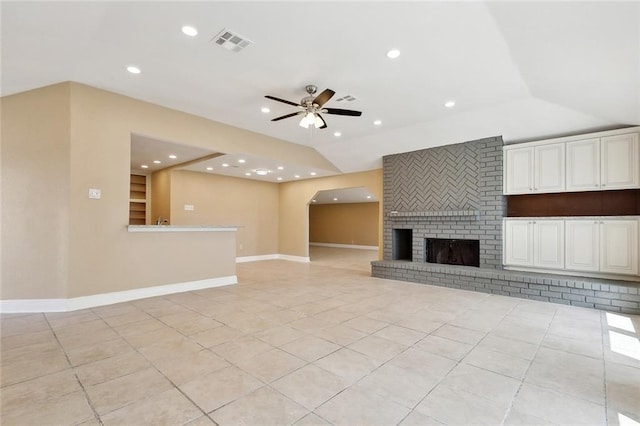 unfurnished living room with lofted ceiling, ceiling fan, visible vents, and light tile patterned flooring