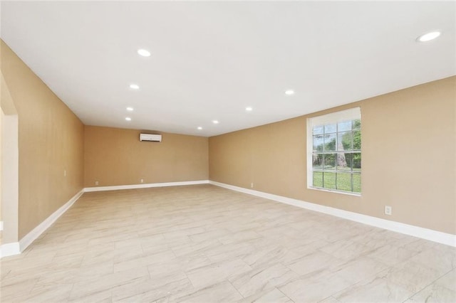 empty room with baseboards and recessed lighting