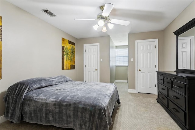 bedroom featuring visible vents, light carpet, baseboards, and ceiling fan