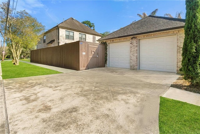 5878 General Haig St, New Orleans, LA 70124 - view of property exterior featuring brick siding, roof with shingles, a garage, and a gate