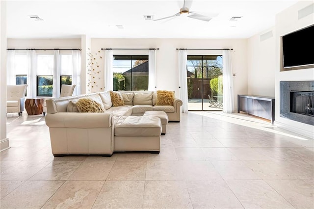 5878 General Haig St, New Orleans, LA 70124 - living room featuring a ceiling fan, a fireplace, and light tile patterned floors