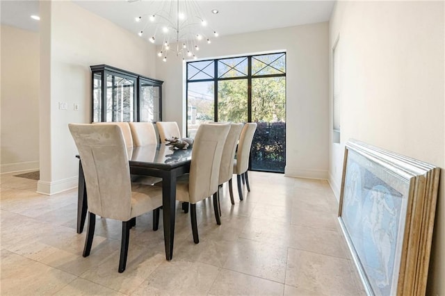 5878 General Haig St, New Orleans, LA 70124 - dining space featuring a chandelier and baseboards