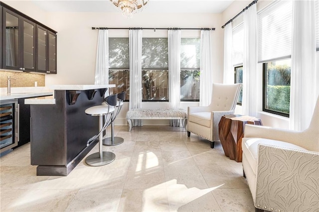 5878 General Haig St, New Orleans, LA 70124 - bar with tasteful backsplash, wine cooler, a chandelier, and light tile patterned floors
