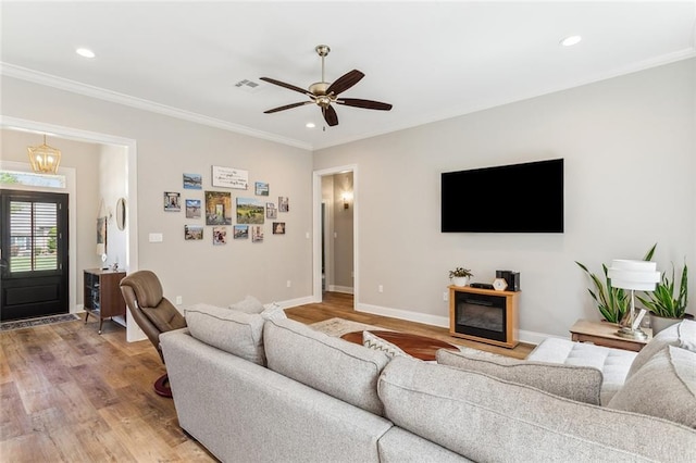 living area with recessed lighting, ornamental molding, and light wood-style floors