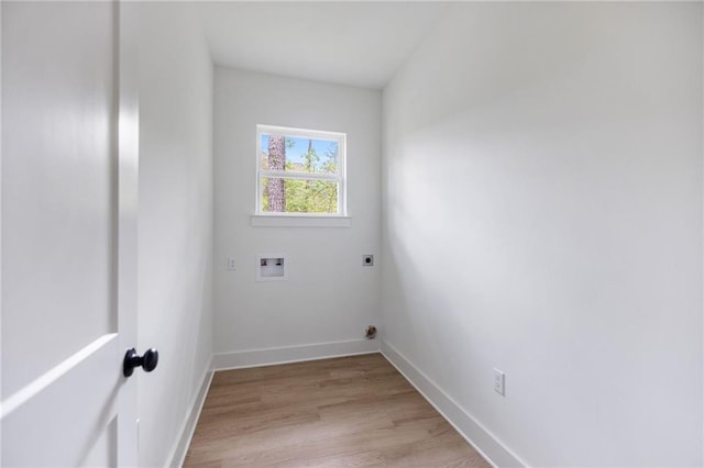 laundry room with hookup for a washing machine, hookup for an electric dryer, light wood-style flooring, baseboards, and laundry area