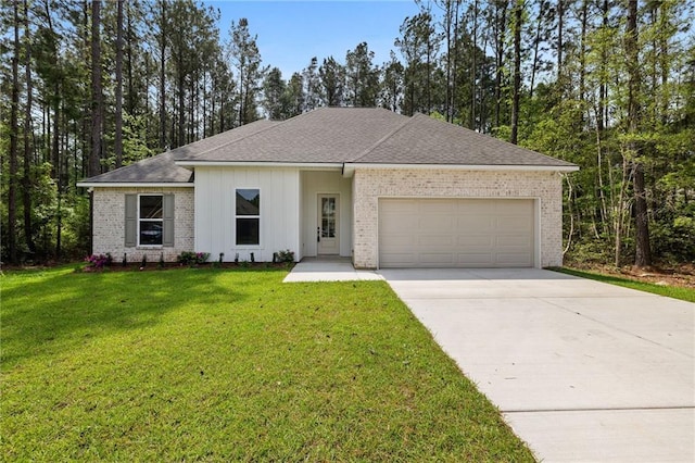single story home with brick siding, an attached garage, a front lawn, and concrete driveway