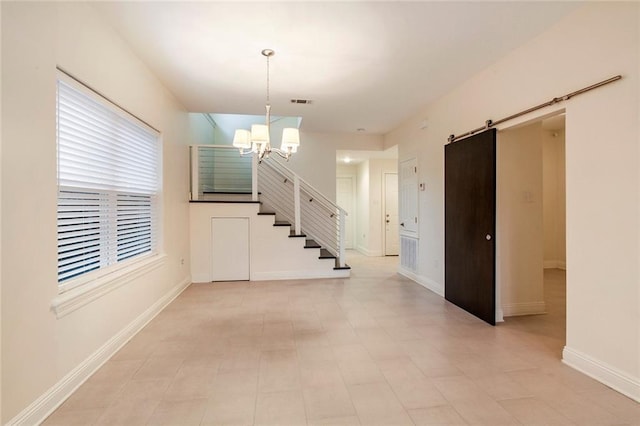 interior space featuring visible vents, baseboards, stairs, a barn door, and an inviting chandelier