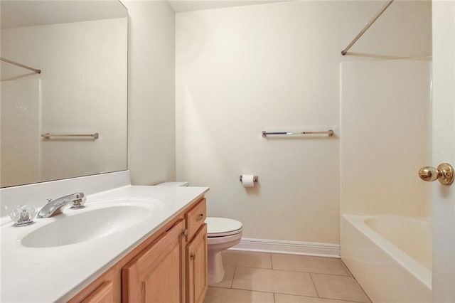 bathroom with vanity, baseboards, tile patterned floors, toilet, and shower / bathtub combination