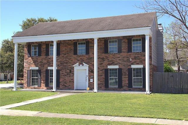 4043 S Pin Oak Ave, New Orleans, LA 70131 - view of front of property featuring a front lawn, fence, brick siding, and roof with shingles