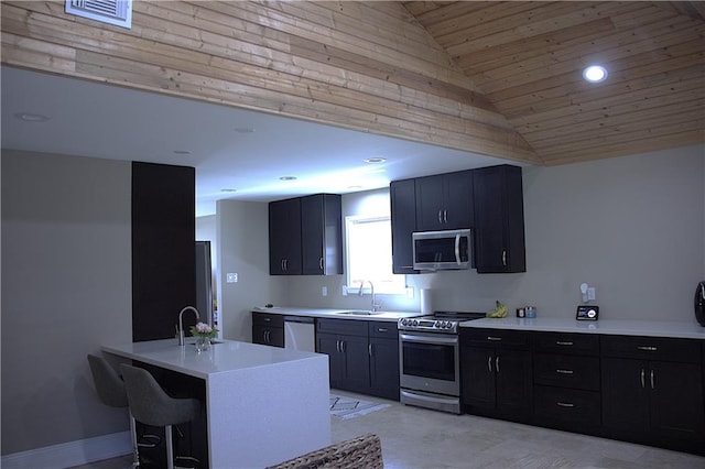 4043 S Pin Oak Ave, New Orleans, LA 70131 - kitchen featuring visible vents, a breakfast bar area, light countertops, stainless steel appliances, and a sink