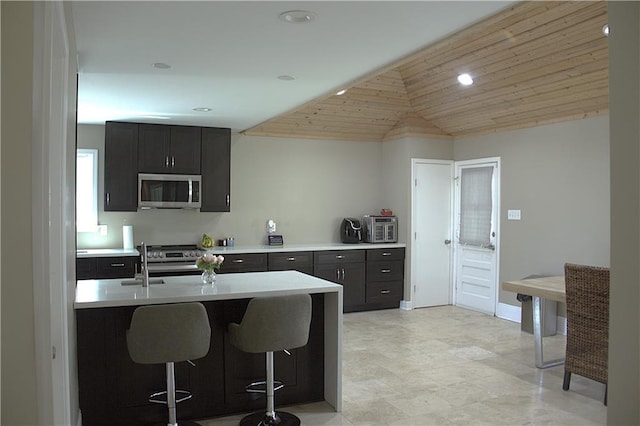 4043 S Pin Oak Ave, New Orleans, LA 70131 - kitchen featuring a breakfast bar area, a sink, stainless steel appliances, light countertops, and wooden ceiling