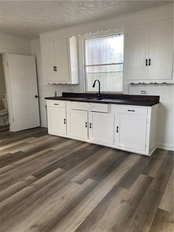 512 Fos Ave, Marrero, LA 70058 - kitchen with a sink, dark countertops, white cabinetry, and dark wood finished floors