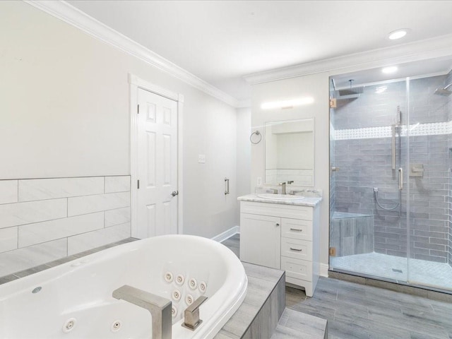 bathroom featuring a shower stall, crown molding, vanity, and a whirlpool tub