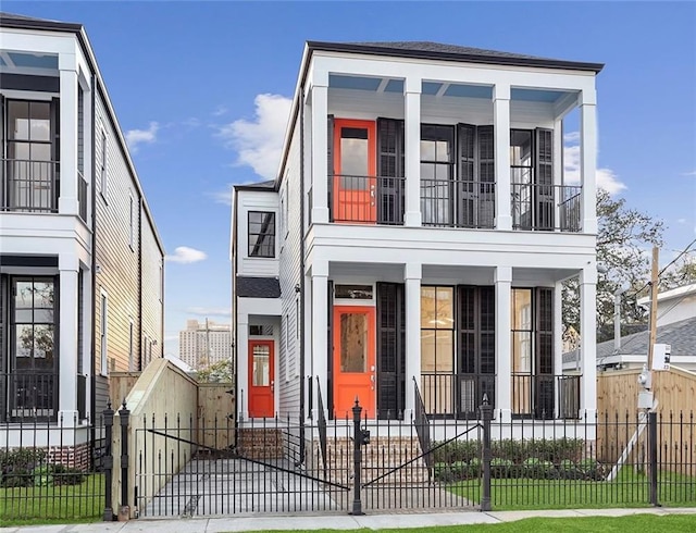 736 Belleville St, New Orleans, LA 70114 - view of front of home featuring a porch, a balcony, a fenced front yard, and a gate