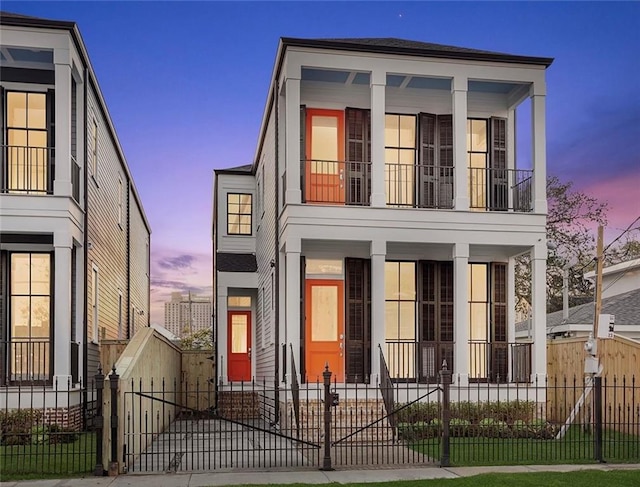 736 Belleville St, New Orleans, LA 70114 - view of front of home featuring covered porch, a balcony, a fenced front yard, and a gate