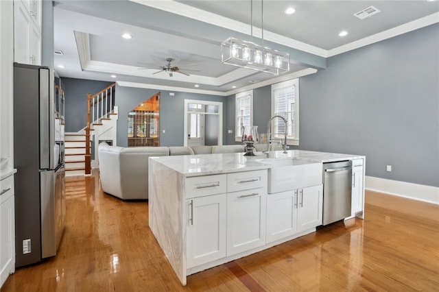 736 Belleville St, New Orleans, LA 70114 - kitchen with stainless steel appliances, recessed lighting, white cabinets, ornamental molding, and a sink